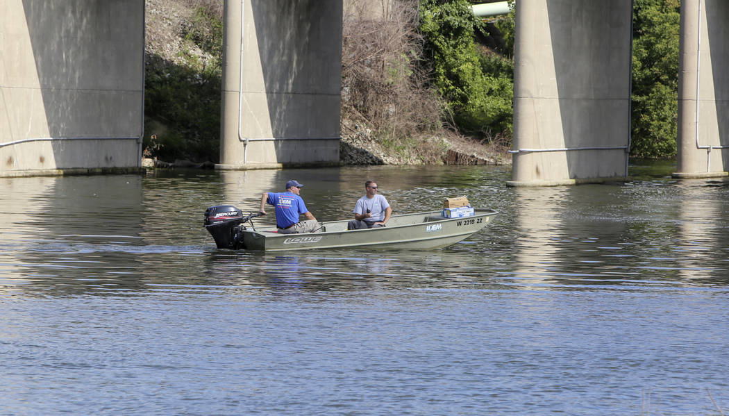 In this Thursday, Aug. 15, 2019, photo officials from IDEM check the waters near Portage Marina ...