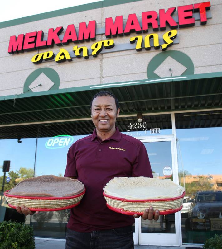 Legesse Tigabu, owner of Melkam Market, an Ethiopian store, poses for photo holding authentic I ...