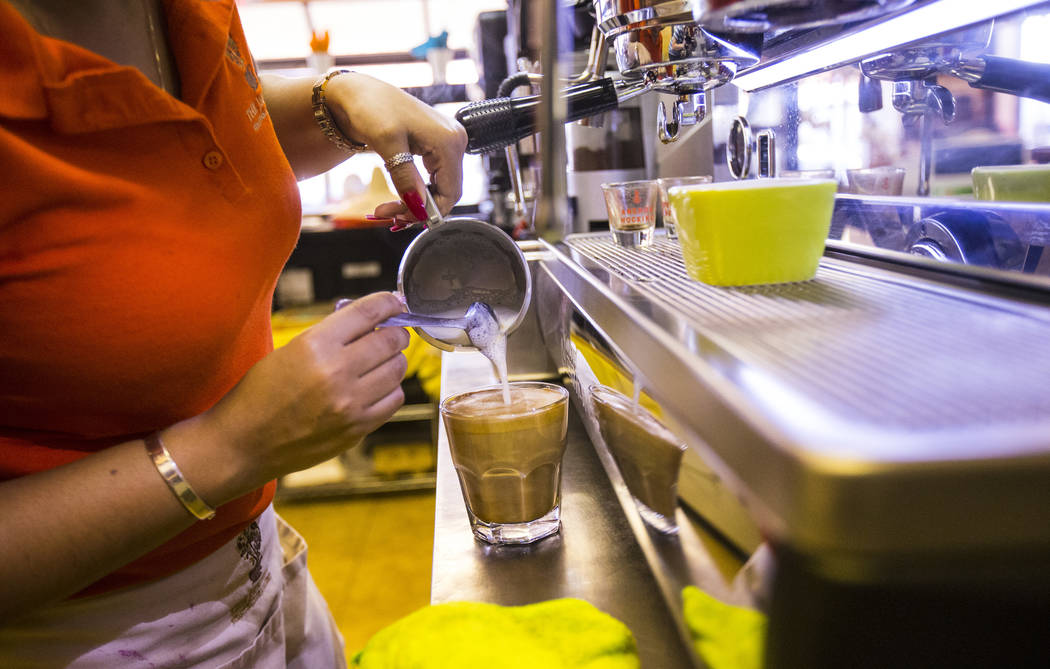 Gio Marongiu, store manager at Java Tree, prepares coffee at the store at Flamingo Road and Dec ...