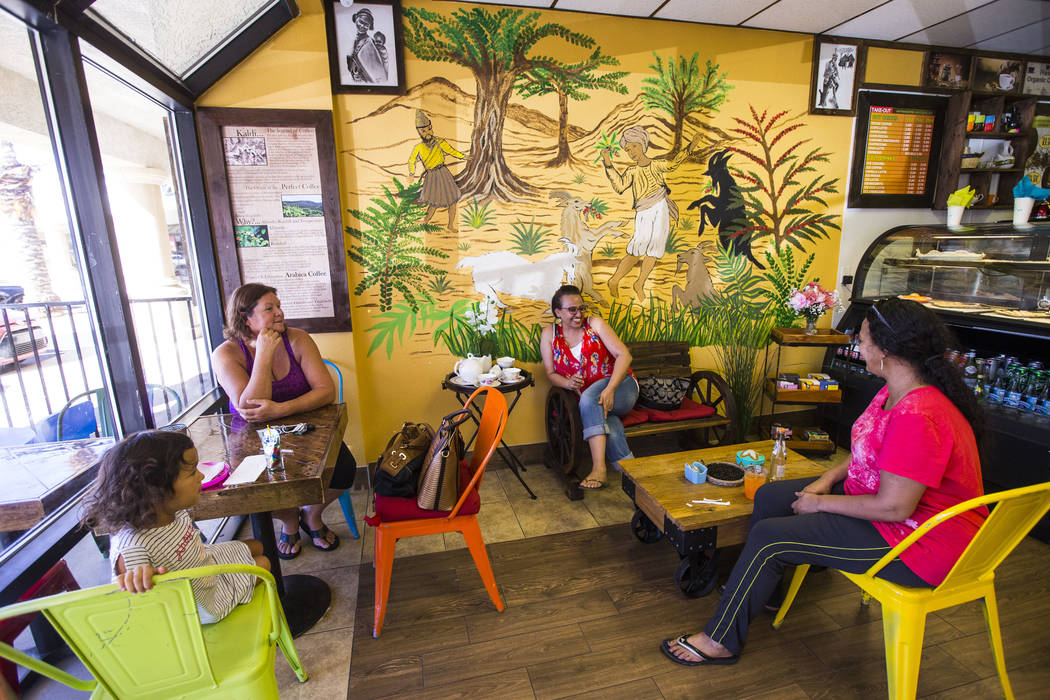 Brenda Colon, upper left, of Las Vegas, waits for tea and coffee to be served while sitting wit ...