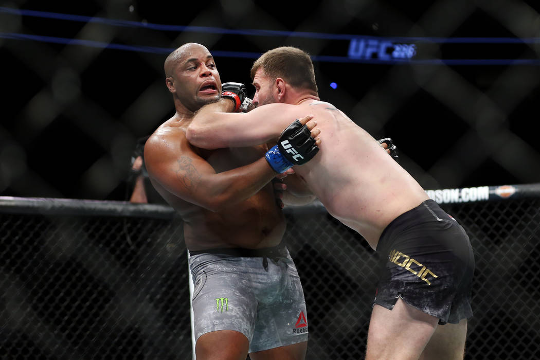 Daniel Cormier, left, battles Stipe Miocic in the heavyweight title bout during UFC 226 at T-Mo ...