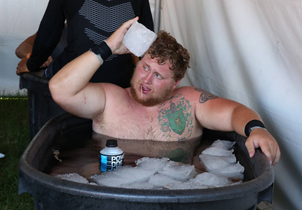 UNLV's offensive lineman Jackson Reynolds cools off in an ice bath after their football practic ...