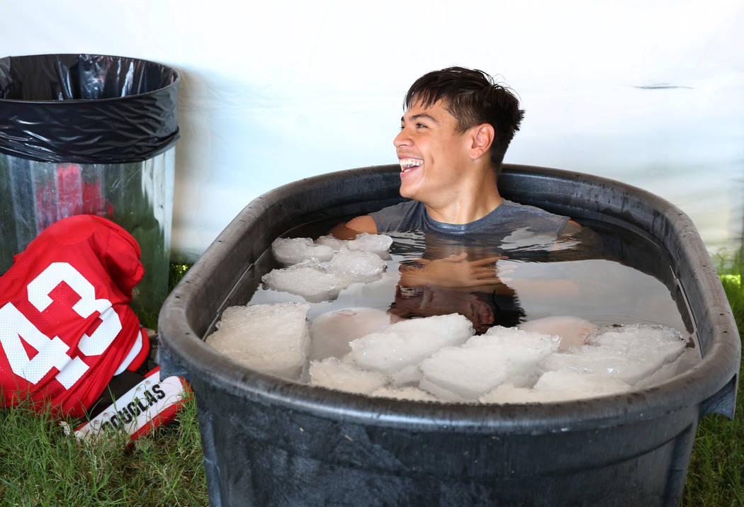 UNLV 's linebacker Malakai Salu, cools off in an ice bath after their football practice on Tues ...