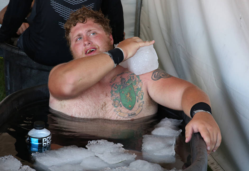 UNLV's offensive lineman Jackson Reynolds cools off in an ice bath after their football practic ...