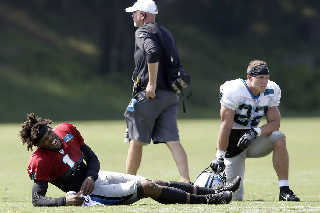 Carolina Panthers quarterback Cam Newton (1) laughs beside Christian McCaffrey (22) during an N ...