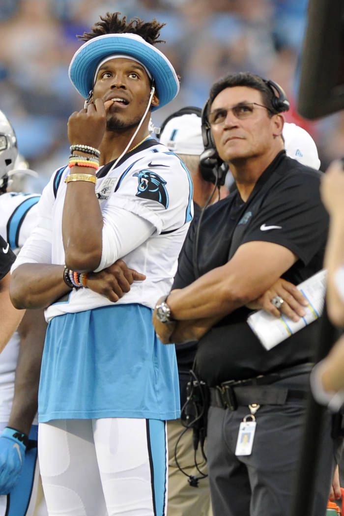 Carolina Panthers quarterback Cam Newton watches a replay with Carolina Panthers head coach Ron ...