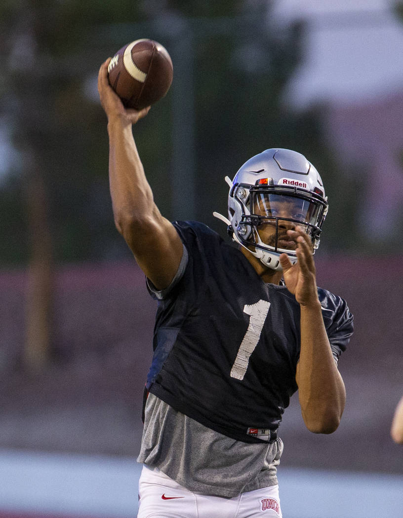 Quarterback Armani Rogers (1) readies to pass to a receiver during the UNLV football team scrim ...