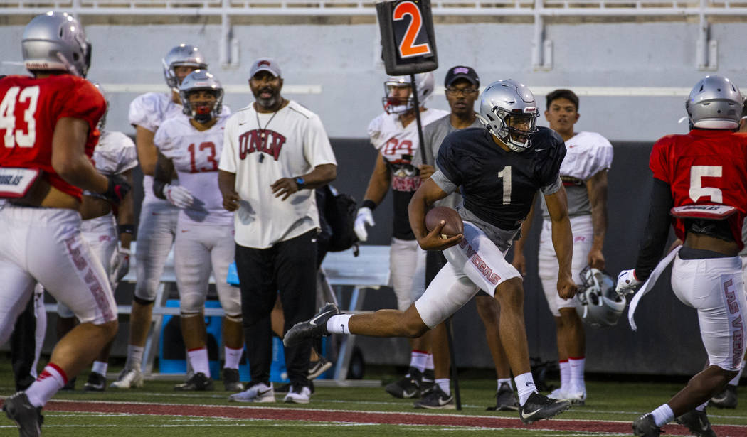 Quarterback Armani Rogers (1) streaks down the sidelines on a run during the UNLV football team ...
