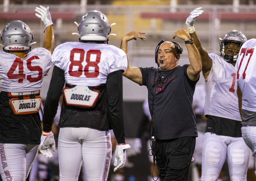 Head coach Tony Sanchez and players call for the ball and a play reset during the UNLV football ...