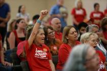 Gloria Corder, left, raises her hand as she yells "Enough", during an event by the Ne ...