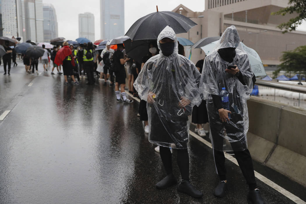 Protesters march in the rain in Hong Kong Sunday, Aug. 18, 2019. Heavy rain fell on tens of tho ...
