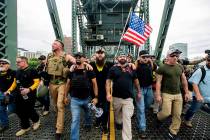 Members of the Proud Boys and other right-wing demonstrators march across the Hawthorne Bridge ...