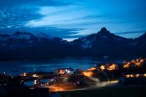 In this photo taken late Friday, Aug. 16, 2019, homes are illuminated after the sunset in Tasii ...
