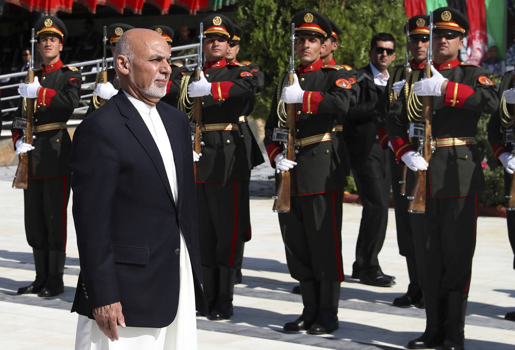In this photo released by the Afghan Presidential Palace, Afghan President Ashraf Ghani inspect ...