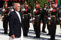 In this photo released by the Afghan Presidential Palace, Afghan President Ashraf Ghani inspect ...