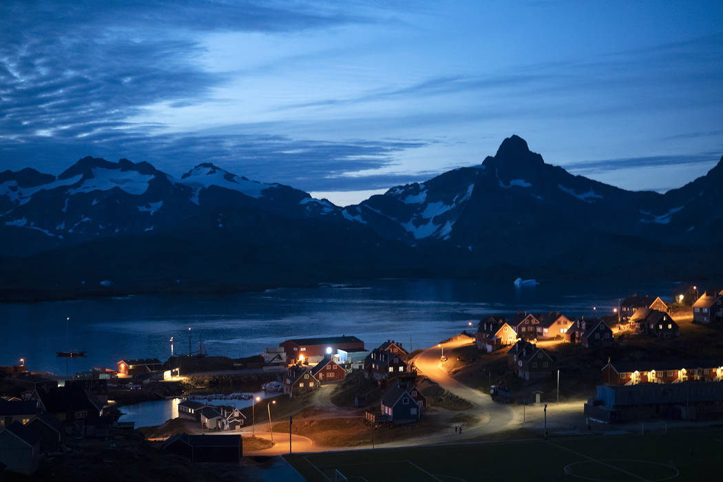 In this photo taken late Friday, Aug. 16, 2019, homes are illuminated after the sunset in Tasii ...