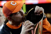 Clemson head coach Dabo Swinney kisses the championship trophy after the NCAA college football ...