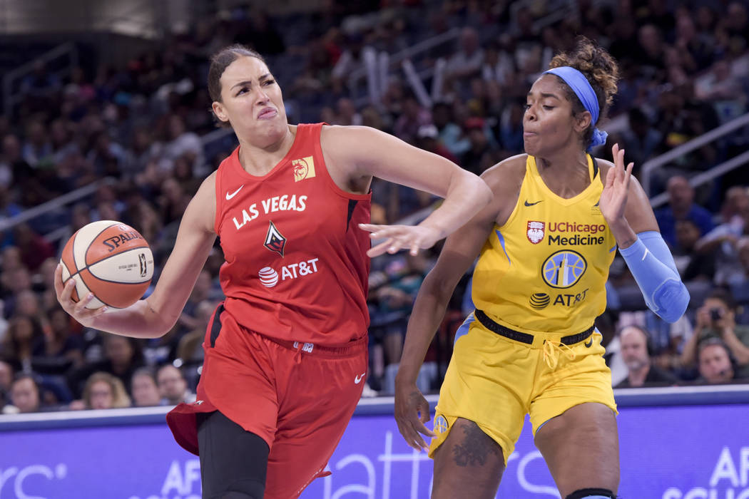 Las Vegas Aces' Liz Cambage moves around the Chicago Sky's Cheyenne Parker during the second ha ...