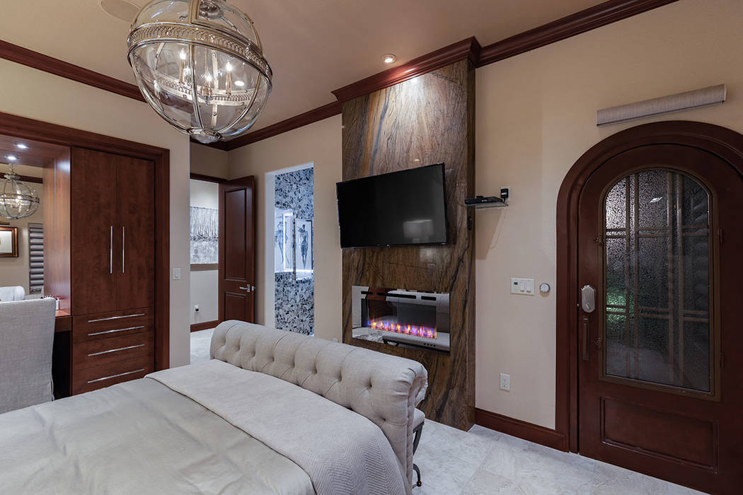 The master bedroom has a modern fireplace. (David Reisman Real Estate Millions)