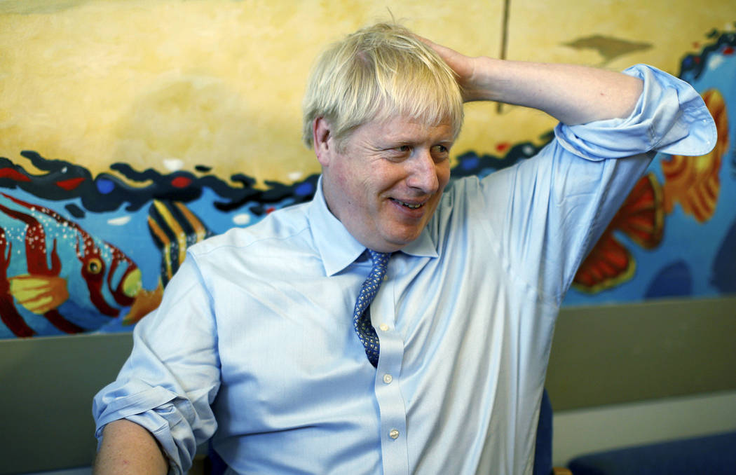 Britain's Prime Minister Boris Johnson speaks with staff during a visit to the Royal Cornwall H ...