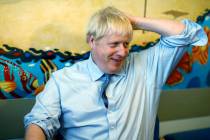 Britain's Prime Minister Boris Johnson speaks with staff during a visit to the Royal Cornwall H ...
