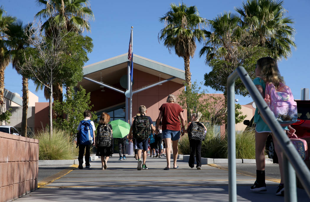 Parents take their children to school at Staton Elementary School in Las Vegas Tuesday, Aug. 20 ...