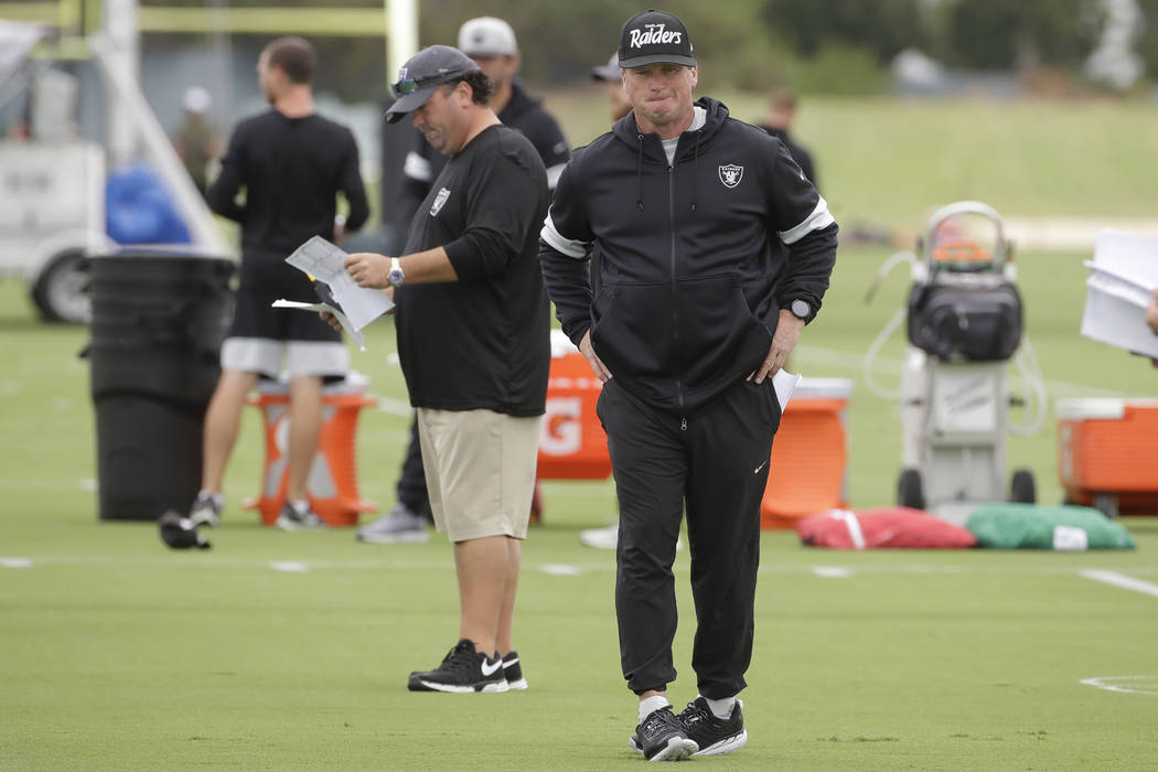 Oakland Raiders head coach Jon Gruden, right, walks in front of defensive coordinator Paul Guen ...