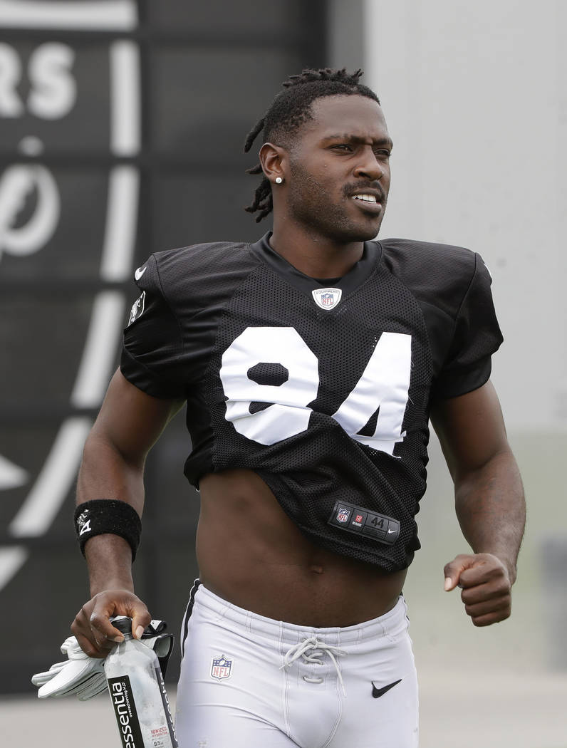 Oakland Raiders' Antonio Brown jogs onto the field before stretching during NFL football practi ...