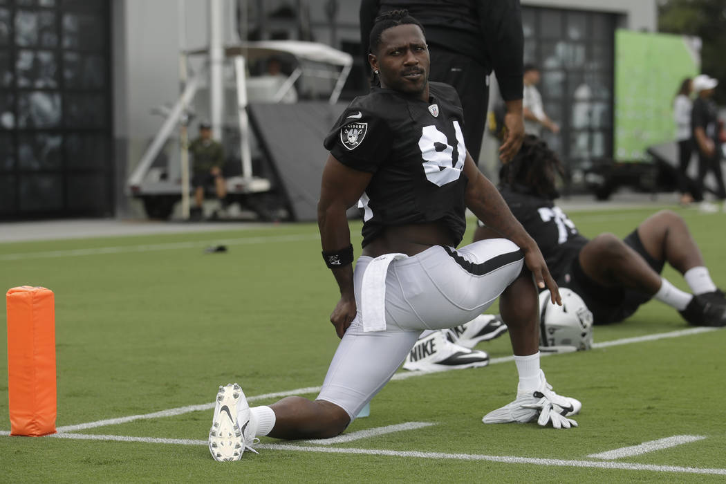 Oakland Raiders' Antonio Brown stretches during NFL football practice in Alameda, Calif., Tuesd ...