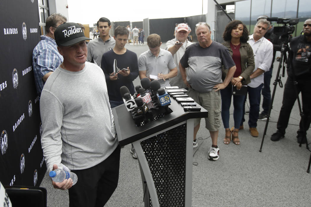 Oakland Raiders head coach Jon Gruden, left, speaks during a news conference after NFL football ...