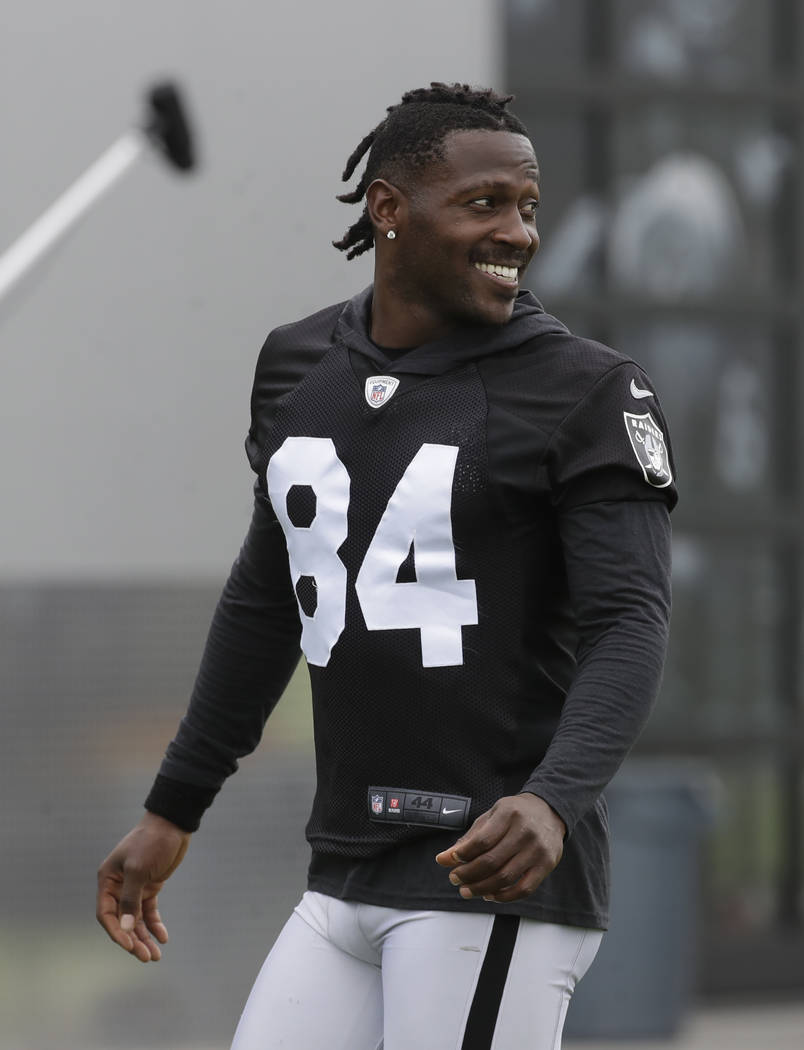 Oakland Raiders' Antonio Brown smiles before stretching during NFL football practice in Alameda ...