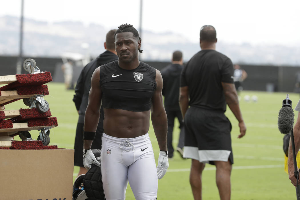 Oakland Raiders' Antonio Brown walks off the field after NFL football practice in Alameda, Cali ...