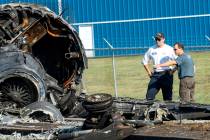 Members of the National Transportation Safety Board looks at the wreckage of a plane that Dale ...