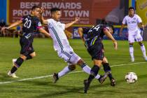 Las Vegas Lights FC forward Jose Villarreal (24, right) sends a kick into the net with Portland ...