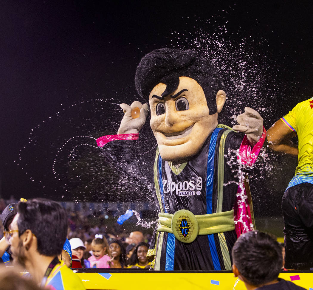 Las Vegas Lights FC mascot Cash the Soccer Rocker is pelted by fans on field during a massive w ...