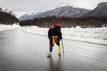 Venezuelan Yeslie Aranda, 57, walks on Route 3 between Tolhuin and Ushuaia, Argentina, Saturday ...
