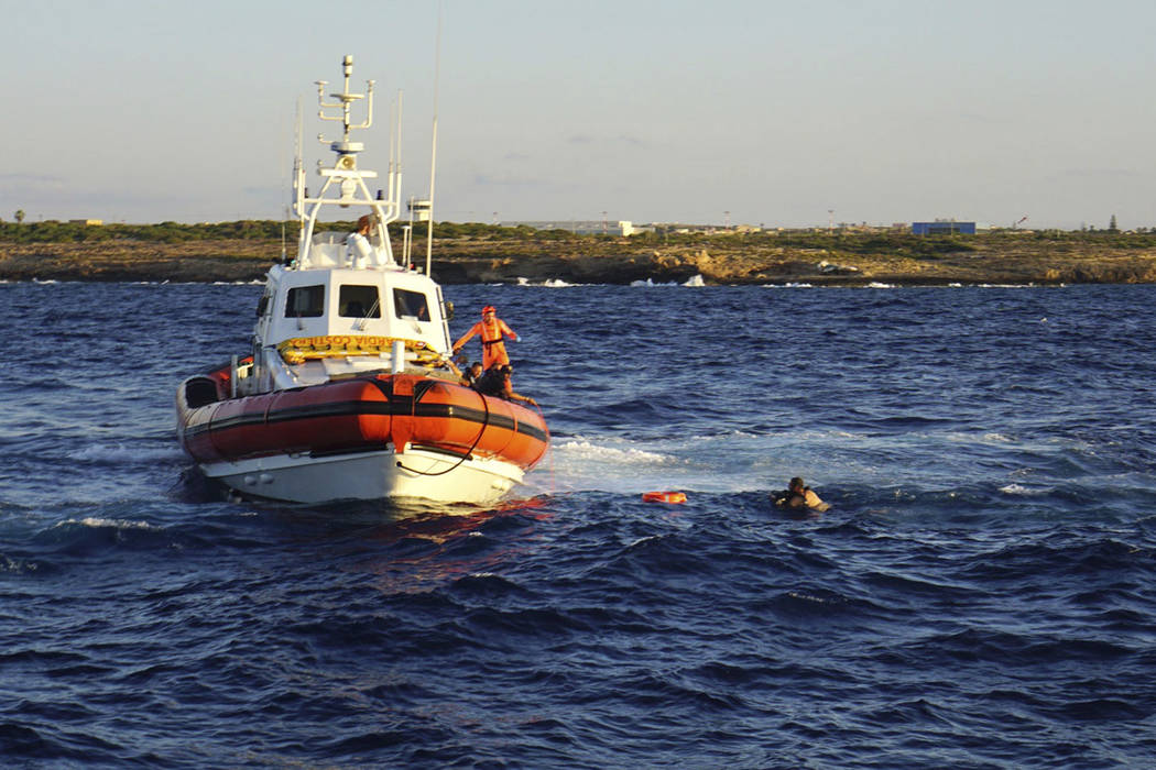 A man who threw himself in the water from the Open Arms vessel, is intercepted by the Italian C ...