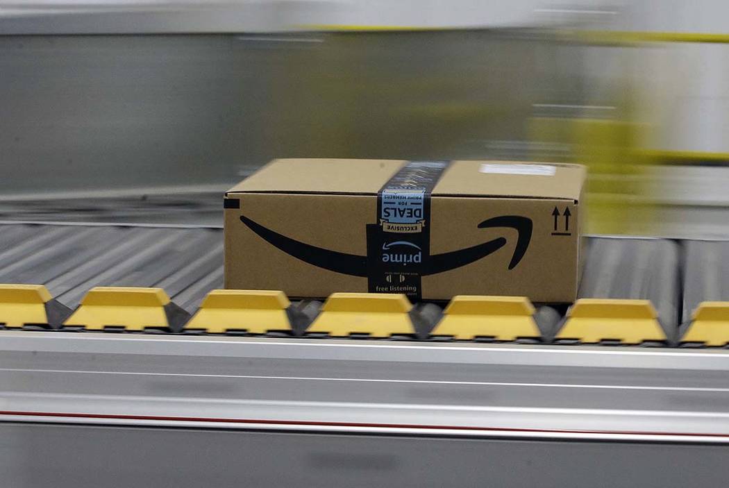 A Feb. 9, 2018, file photo shows a box for an Amazon prime customer moves through the new Amazo ...