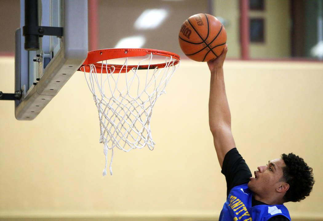 Trinity International junior Daishen Nix dunks the ball during a practice at the Bill and Lilli ...