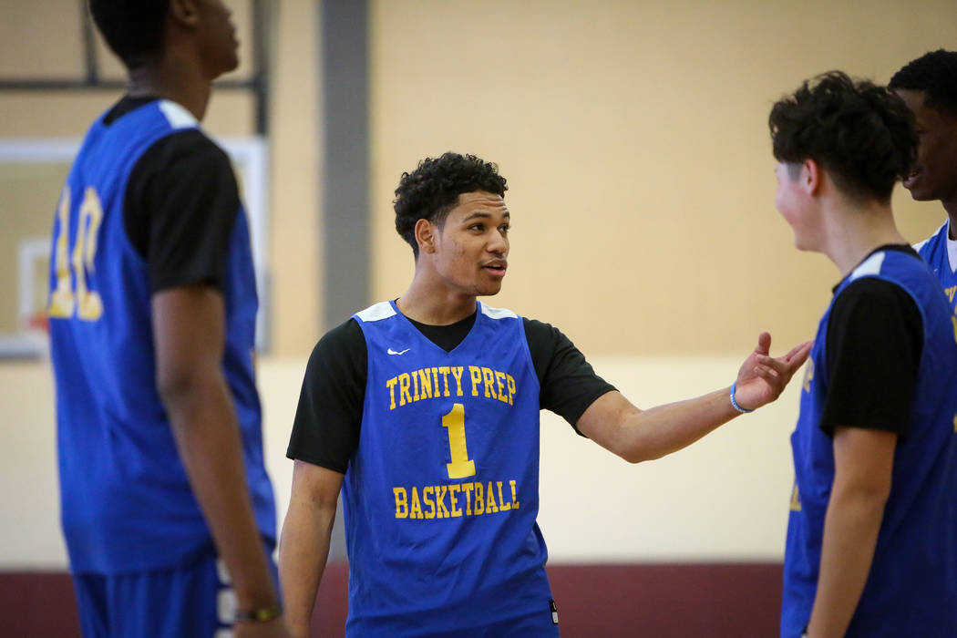 Trinity International junior Daishen Nix talks with his teammates during a practice at the Bill ...