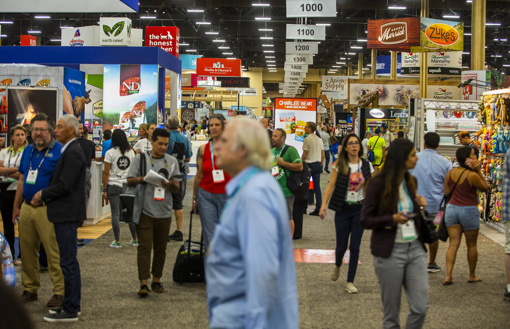 Attendees wander about one of the vast showroom floors of items at the SuperZoo pet products sh ...