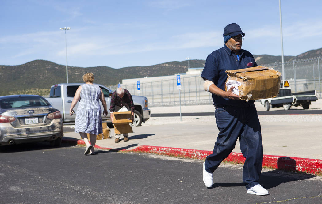 Paul Browning moves boxes full of paperwork to a car after being released from Ely State Prison ...