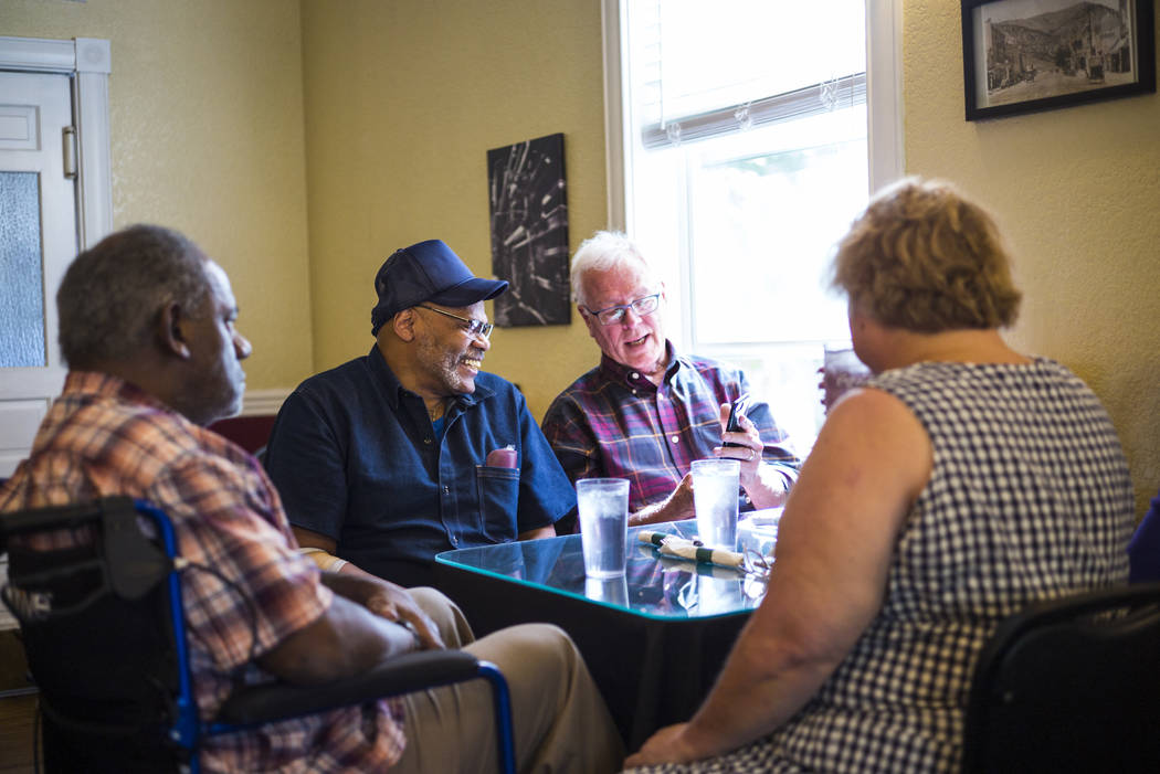 Paul Browning, second from left, learns about the uses of a smartphone with attorney Tim Ford, ...