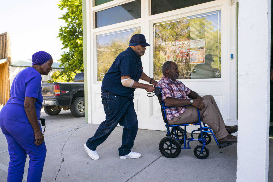 Paul Browning pushes the wheelchair of his brother, Tony, while his mother, Betty, looks on, as ...