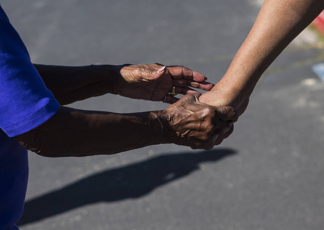 Betty Browning, left, holds the hand of her son Paul after he was released from Ely State Priso ...