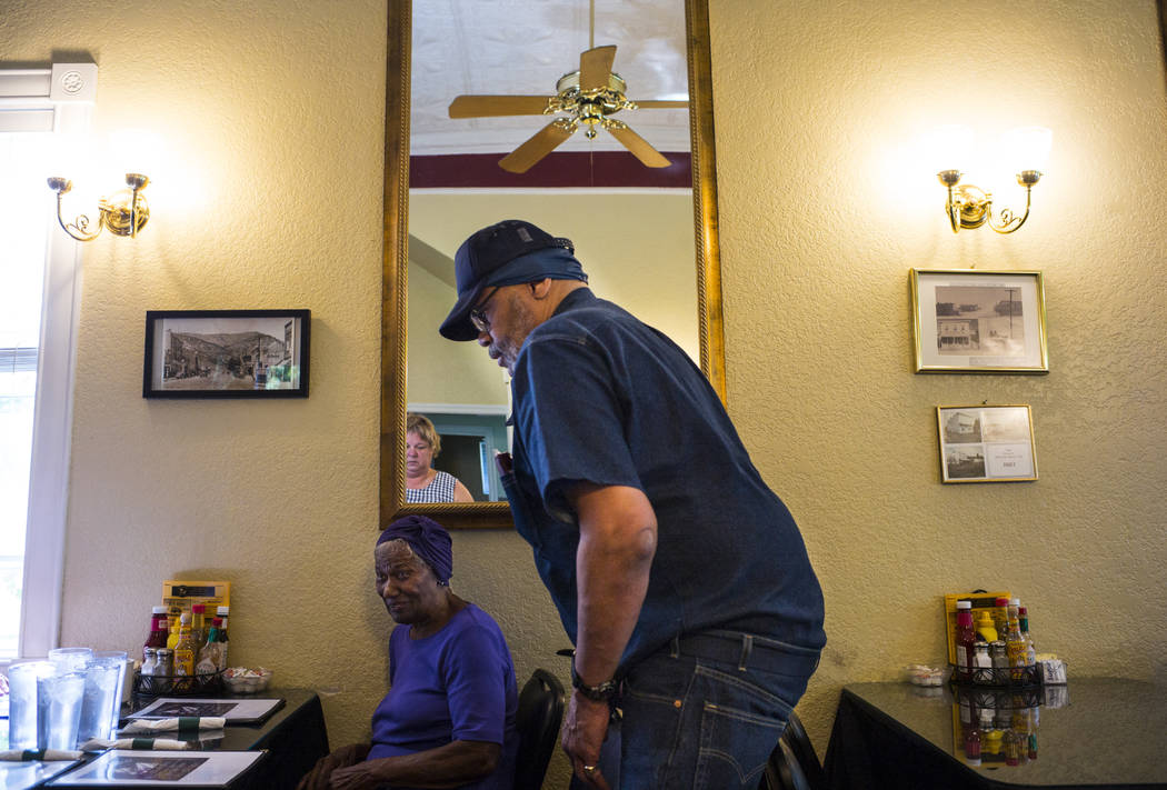 Paul Browning helps his mother, Betty, as the family arrives to eat breakfast in Ely after Paul ...