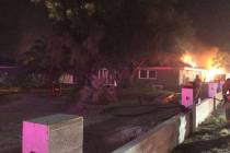 Las Vegas firefighters at the scene of a house fire at 3011 Alta Drive on Wednesday, Aug. 21, 2 ...
