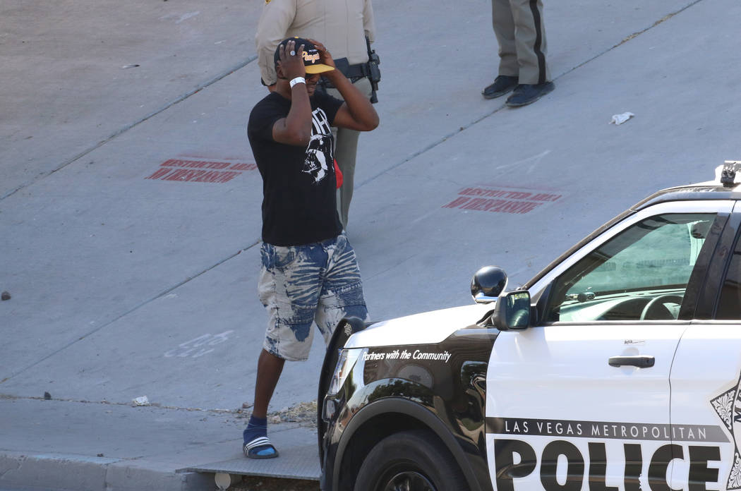 A man reacts at the scene where Las Vegas police are investigating after a person was struck an ...