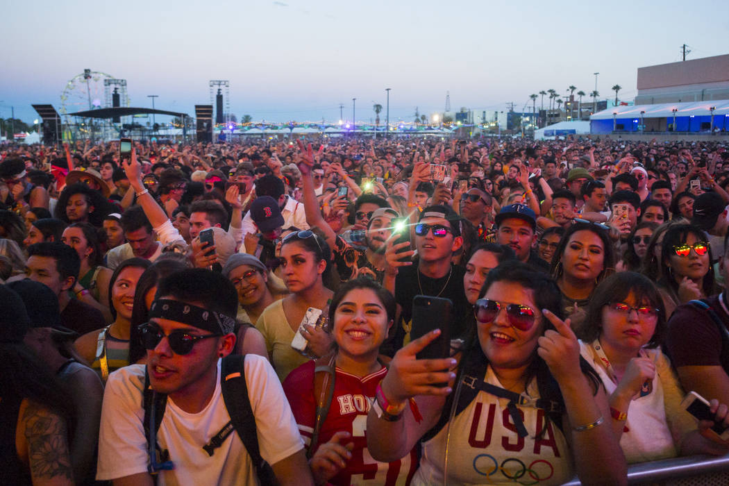 Fans react as French Montana performs at the Downtown stage during the first day of the annual ...