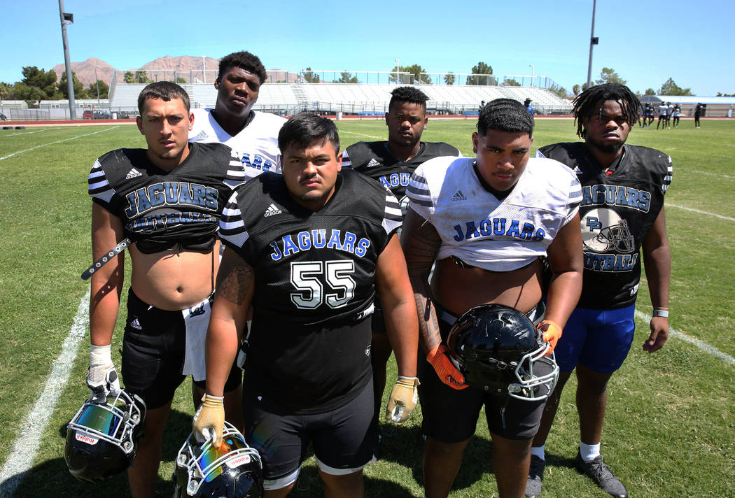 Desert Pines High School defensive linemen Gabriel Lopez, front left, Blaze Homalon (55), Darne ...